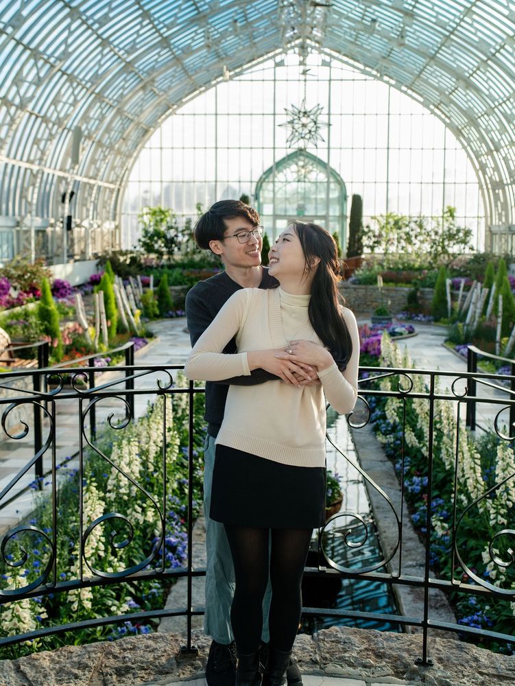 Couple inside a glass conservatory