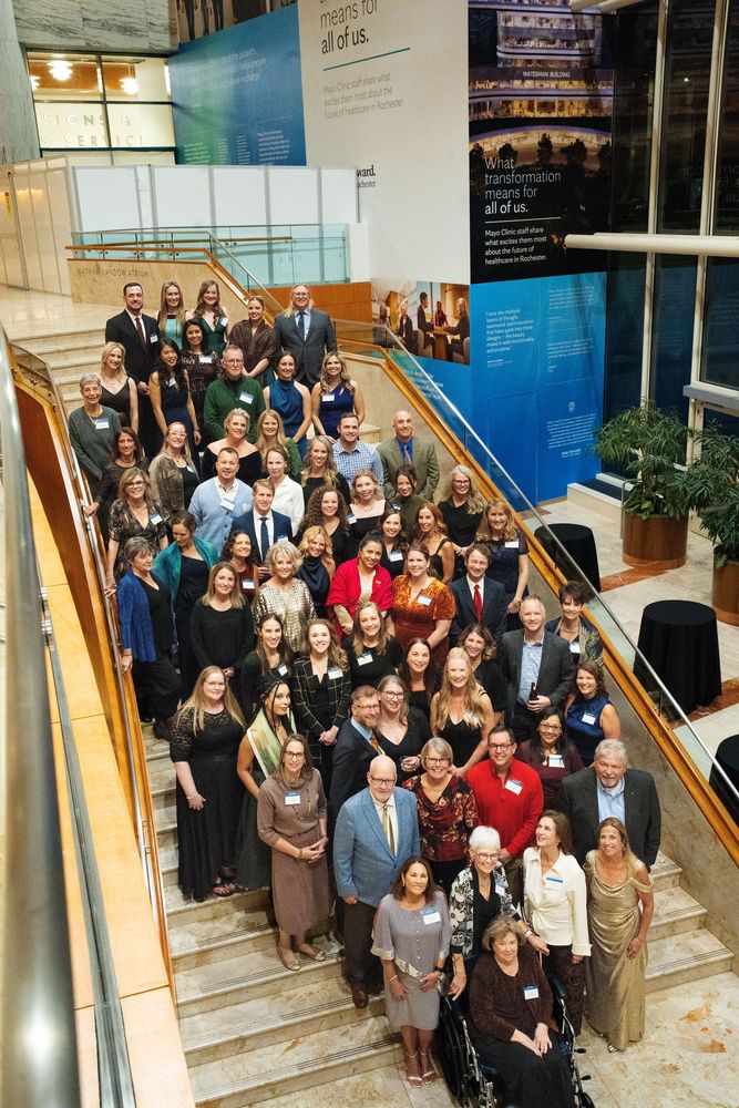 Large group photo on a staircase at a corporate event