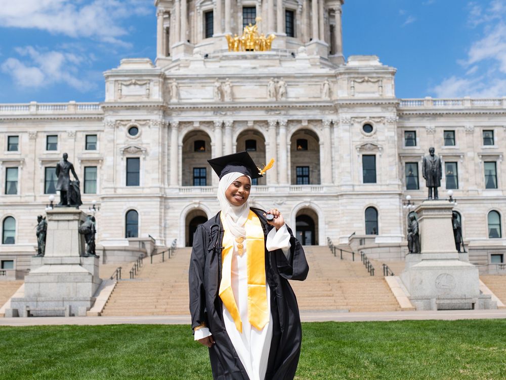 Graduate in front of the Minnesota State Capitol