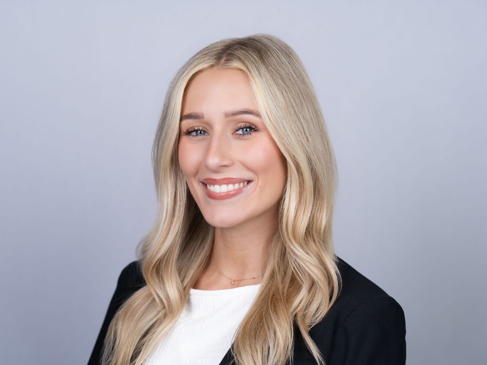 Professional headshot on a light gray backdrop