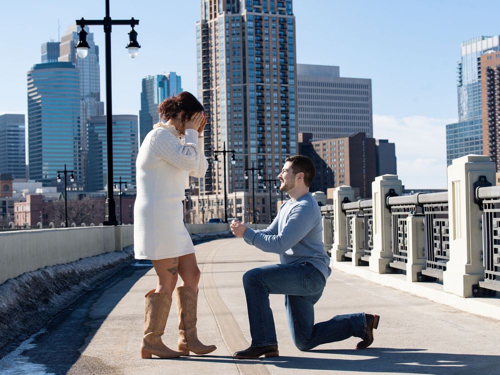 Proposal on a bridge with the skyline behind